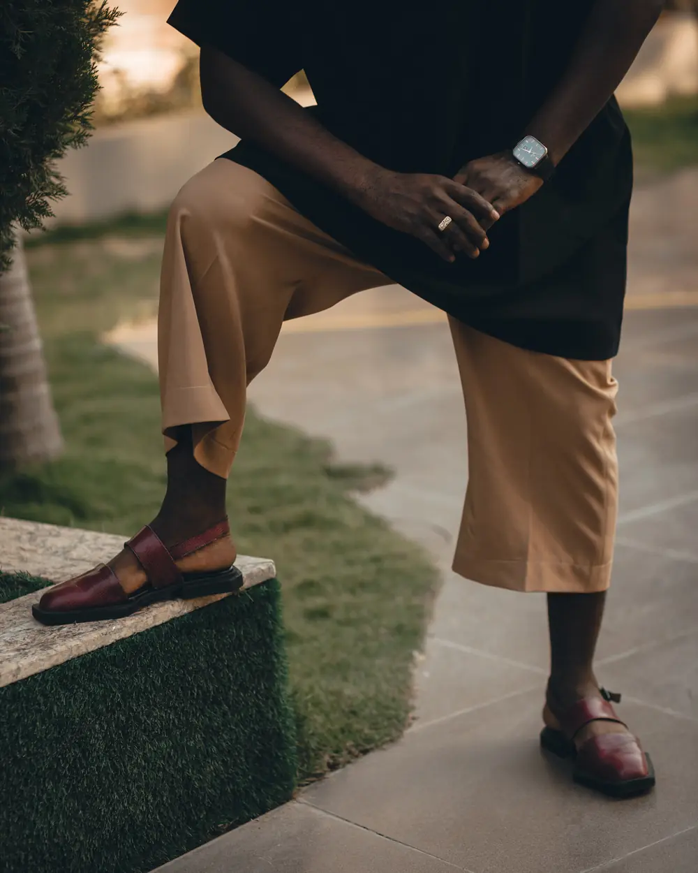 Maroon Peshawari chappals with a beige shalwar